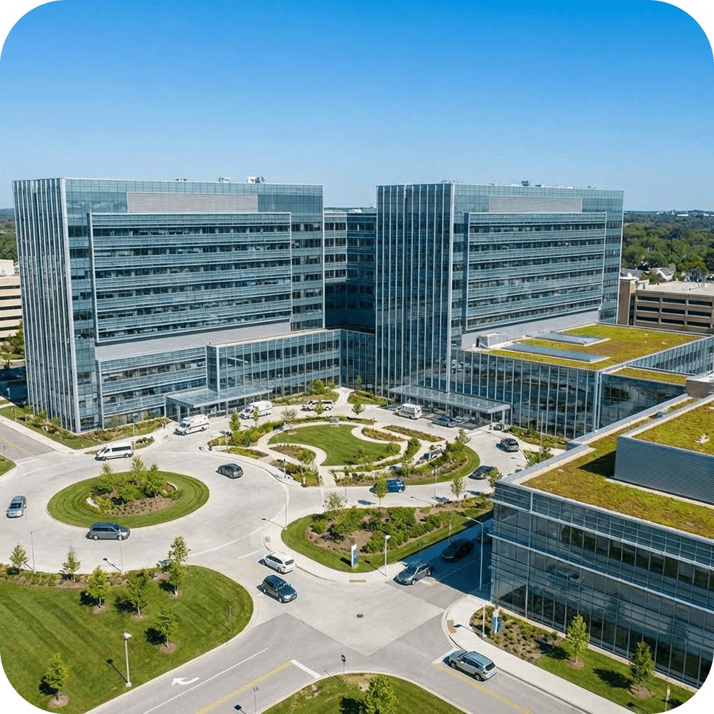 Modern health system campus with a sprawling medical center and landscaped grounds